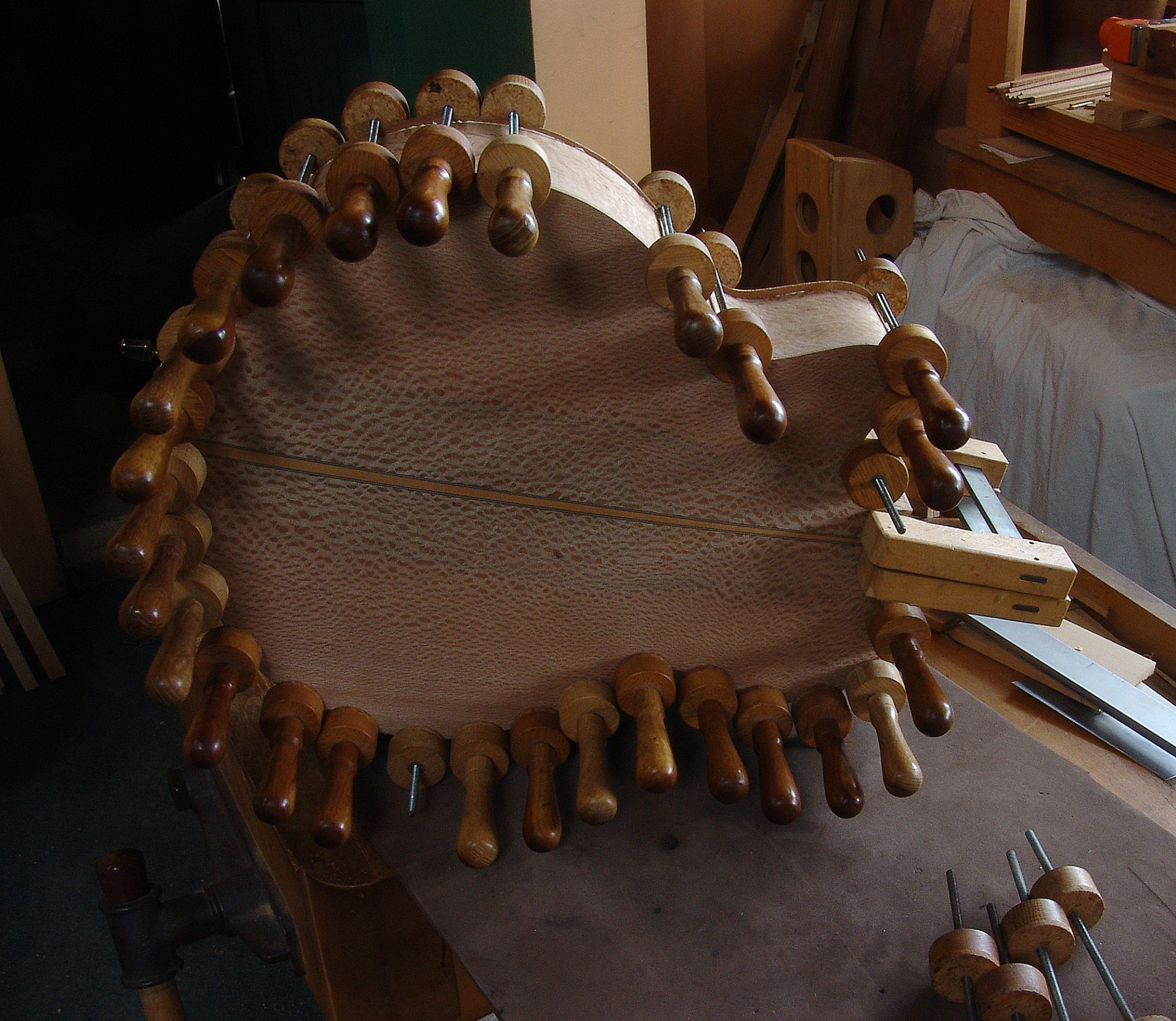 Guitar maker Peter Stephens has clamped the back and soundboard of an acoustic cutaway guitar
