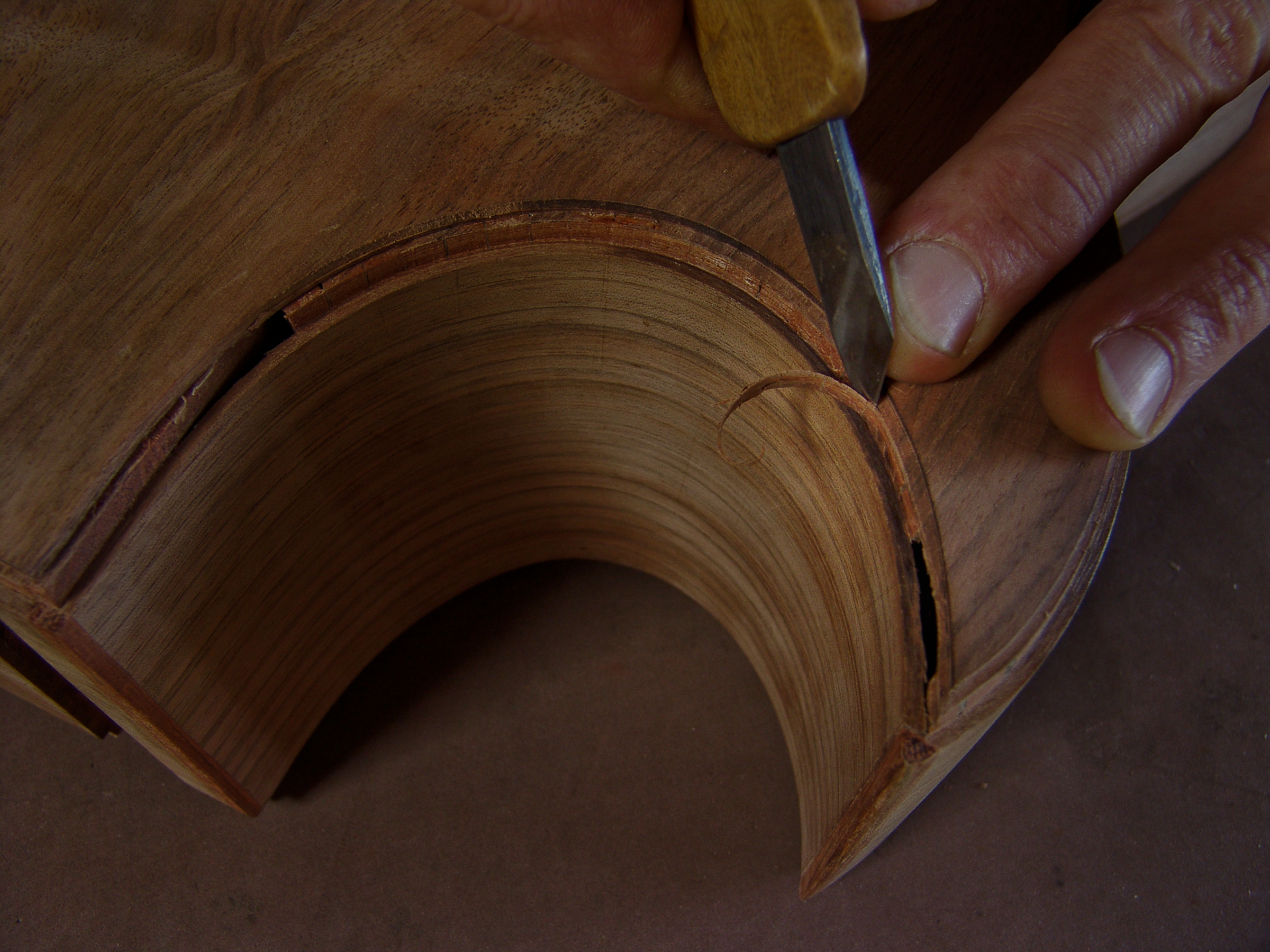 Guitar Maker Peter Stephen cuts out the slot for the purfling of a cutaway acoustic guitar