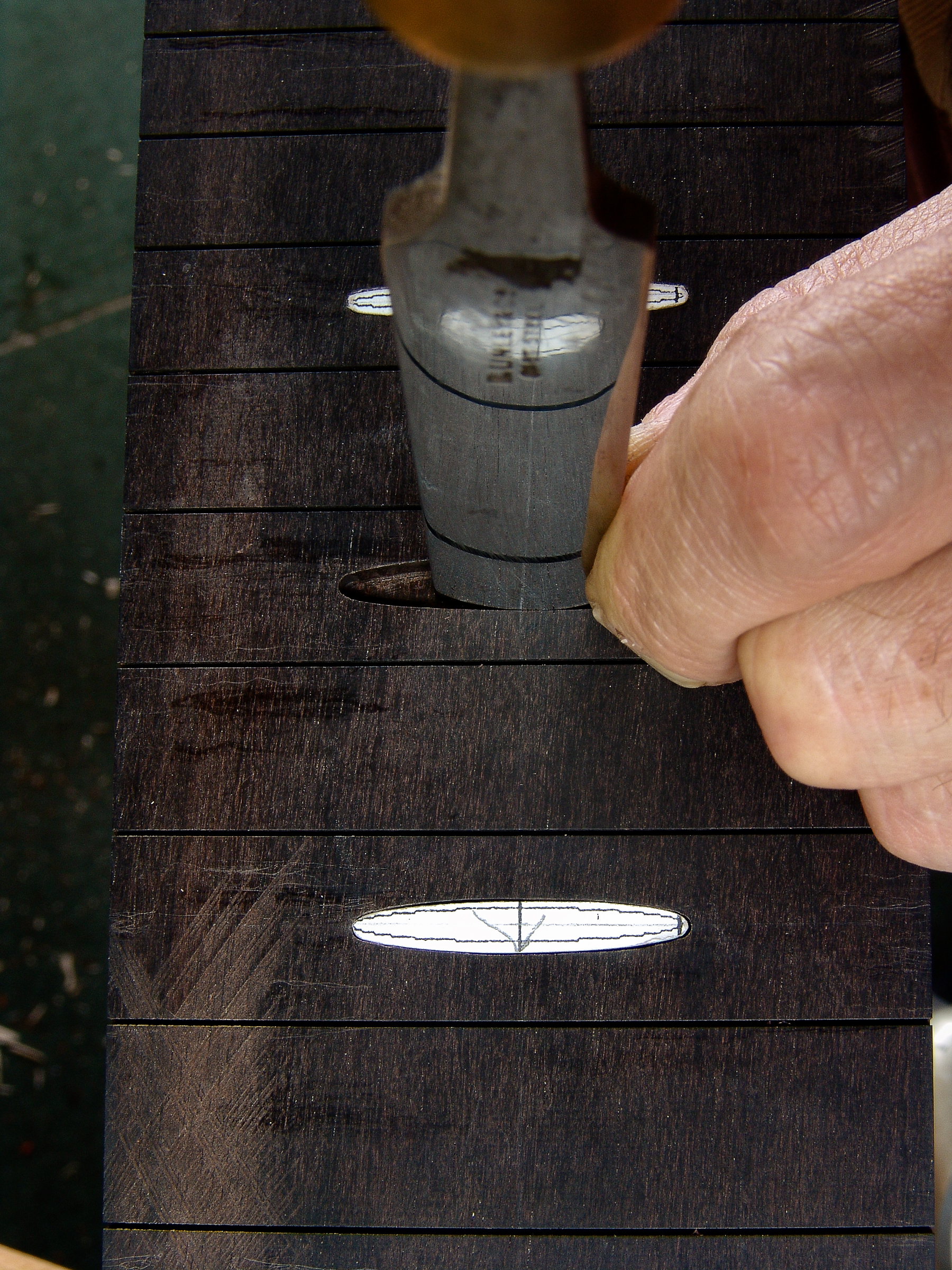 Guitar maker Peter Stephen works the inlays on a guitar neck
