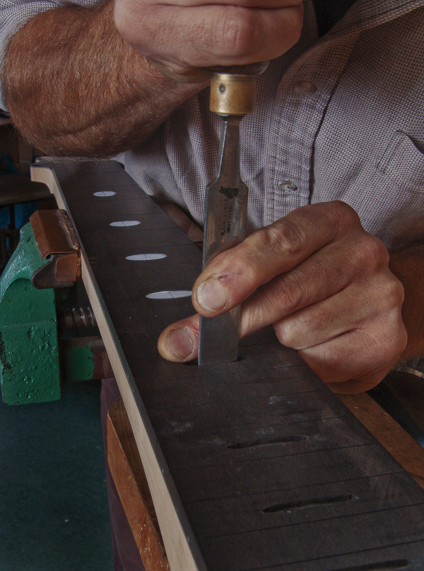 Guitar Maker Peter Stephen works the chisel for the neck inlays