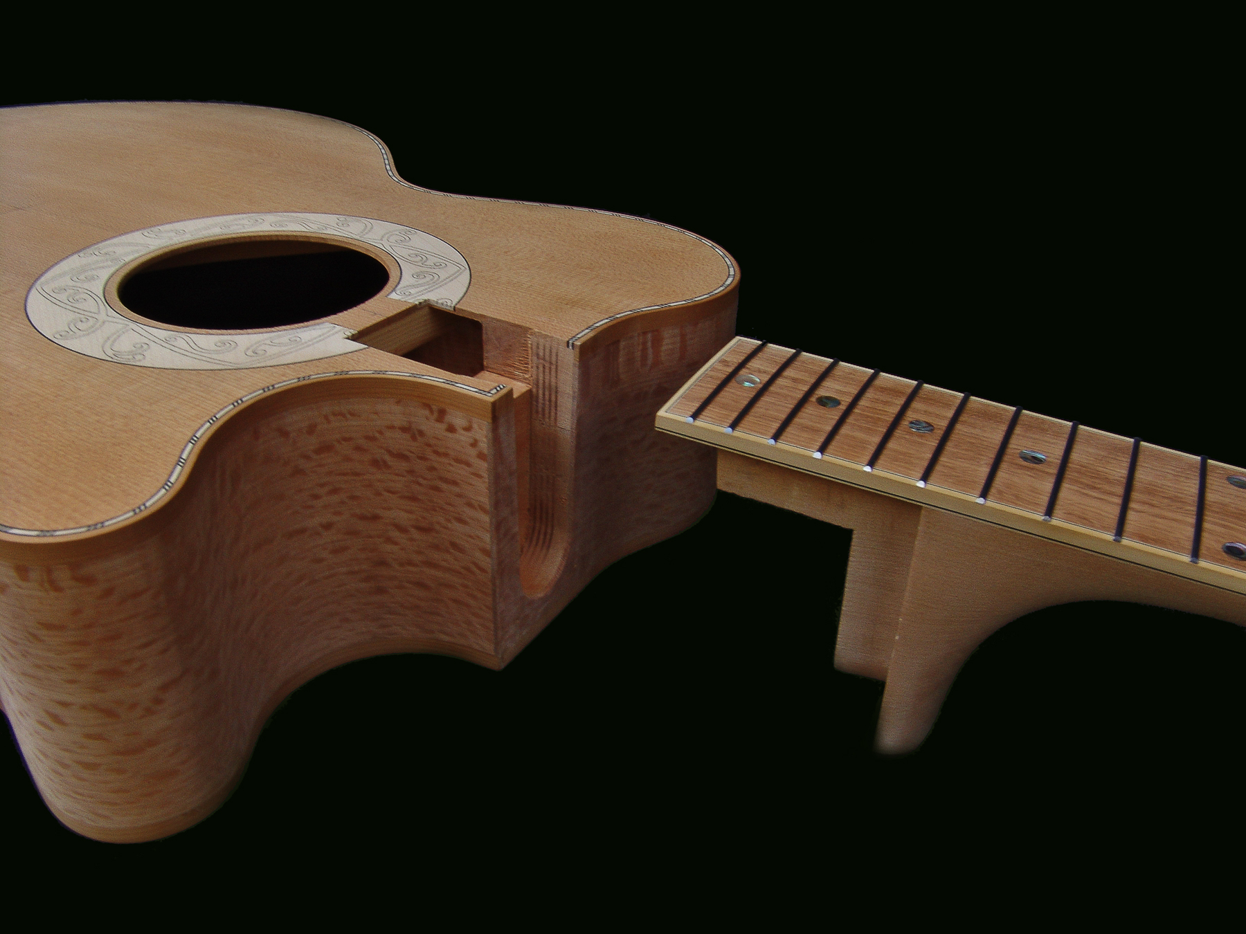Peter Stephen cutaway guitars have a different style of neck join than the dove tail to offer the instrument a solid neck body join
