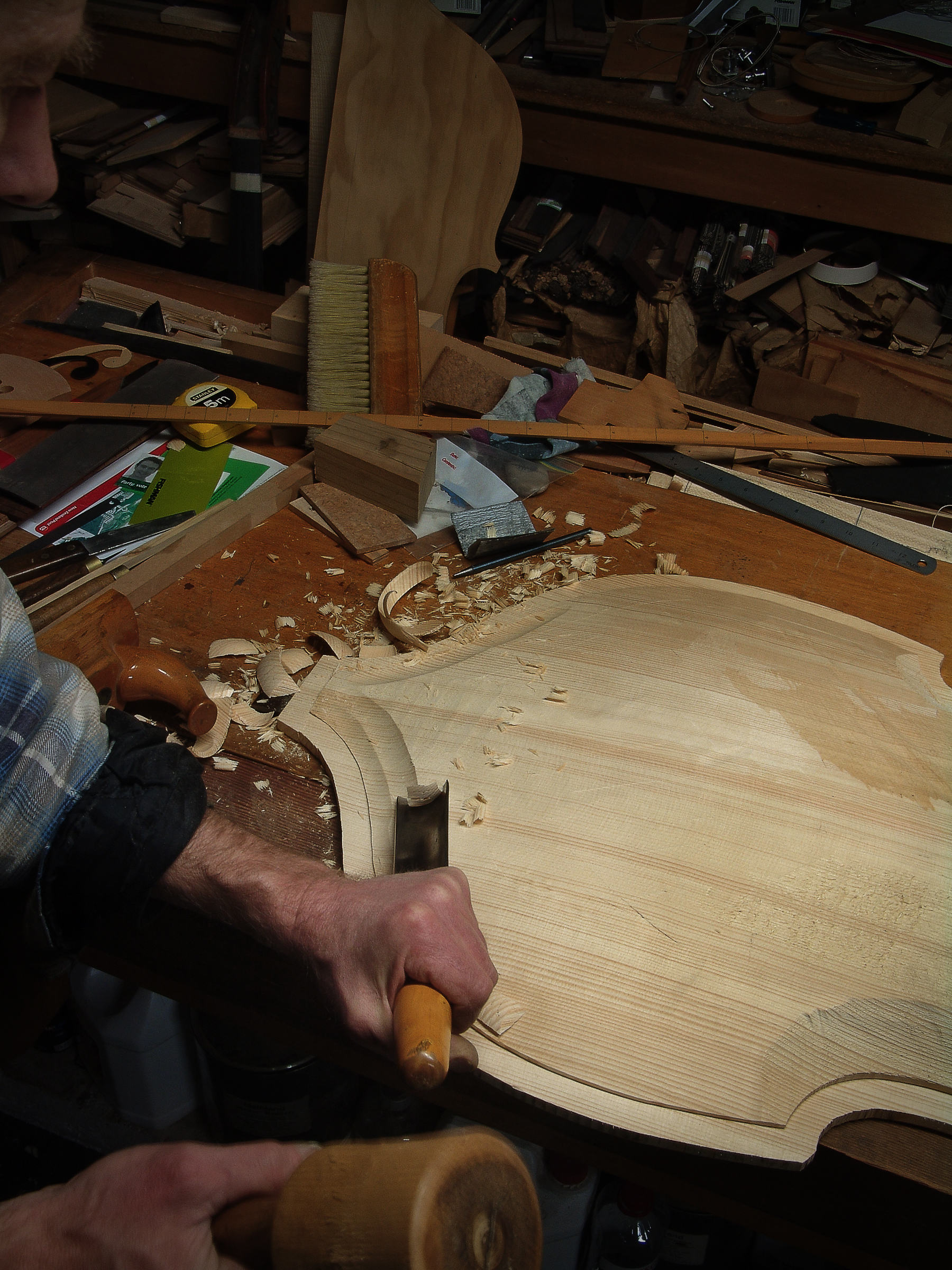 Luthier Peter Stephen chisels out the edges of a solid Spruce soundboard