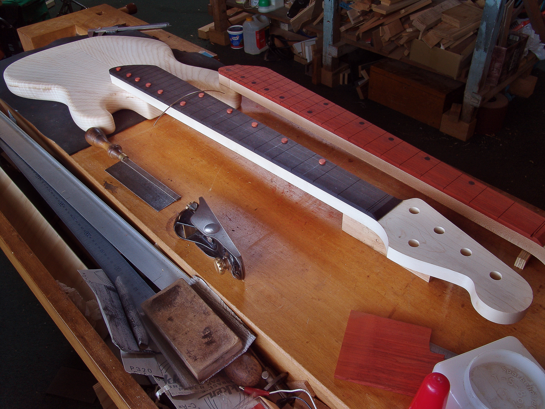 A 5 String Peter Stephen electric bass layout before assembly