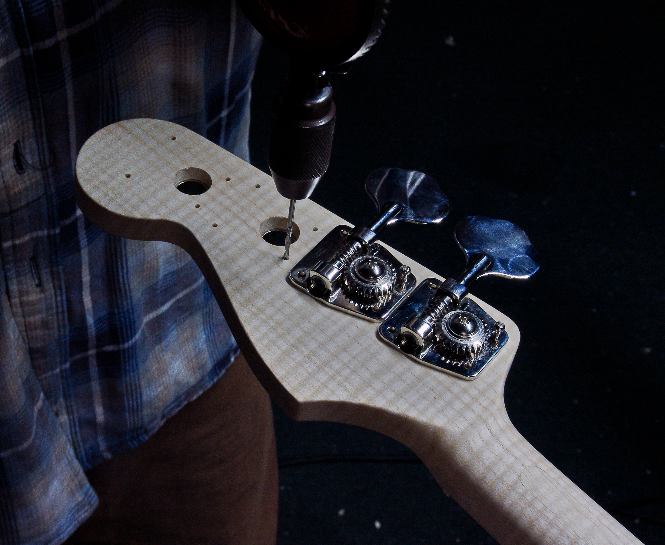 Peter Stephen sets up the machineheads on a Fender Style bass