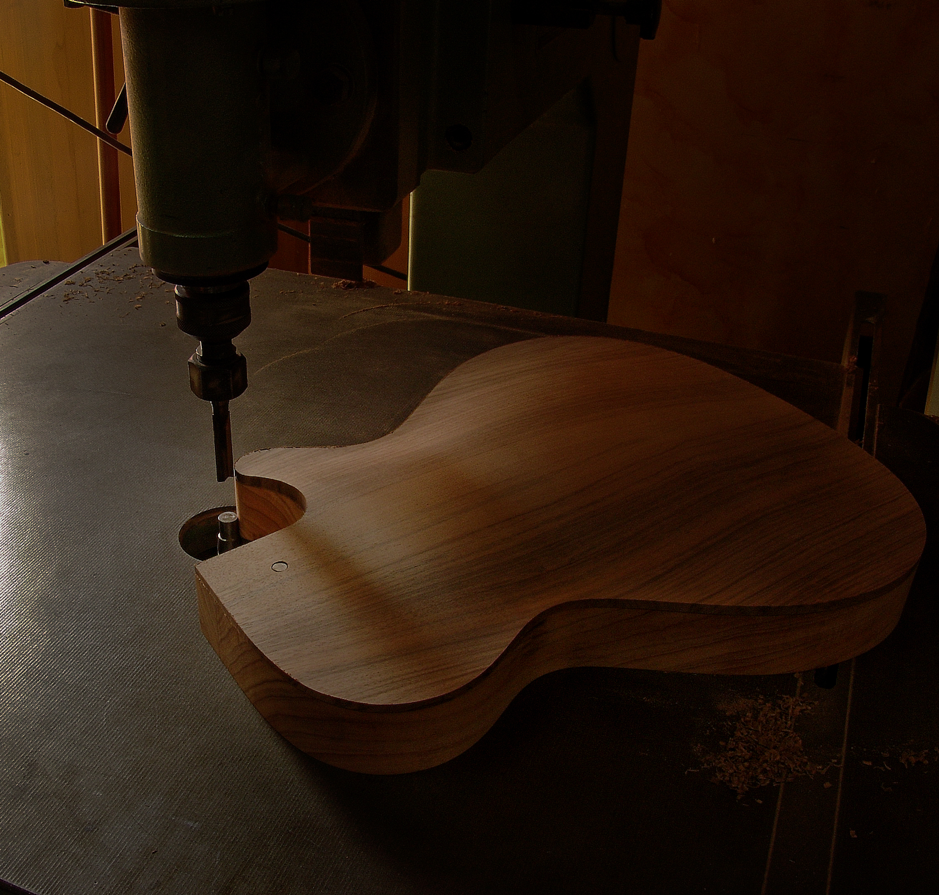 Luthier Peter Stephen is shaping the back and sides of a cutaway acoustic guitar