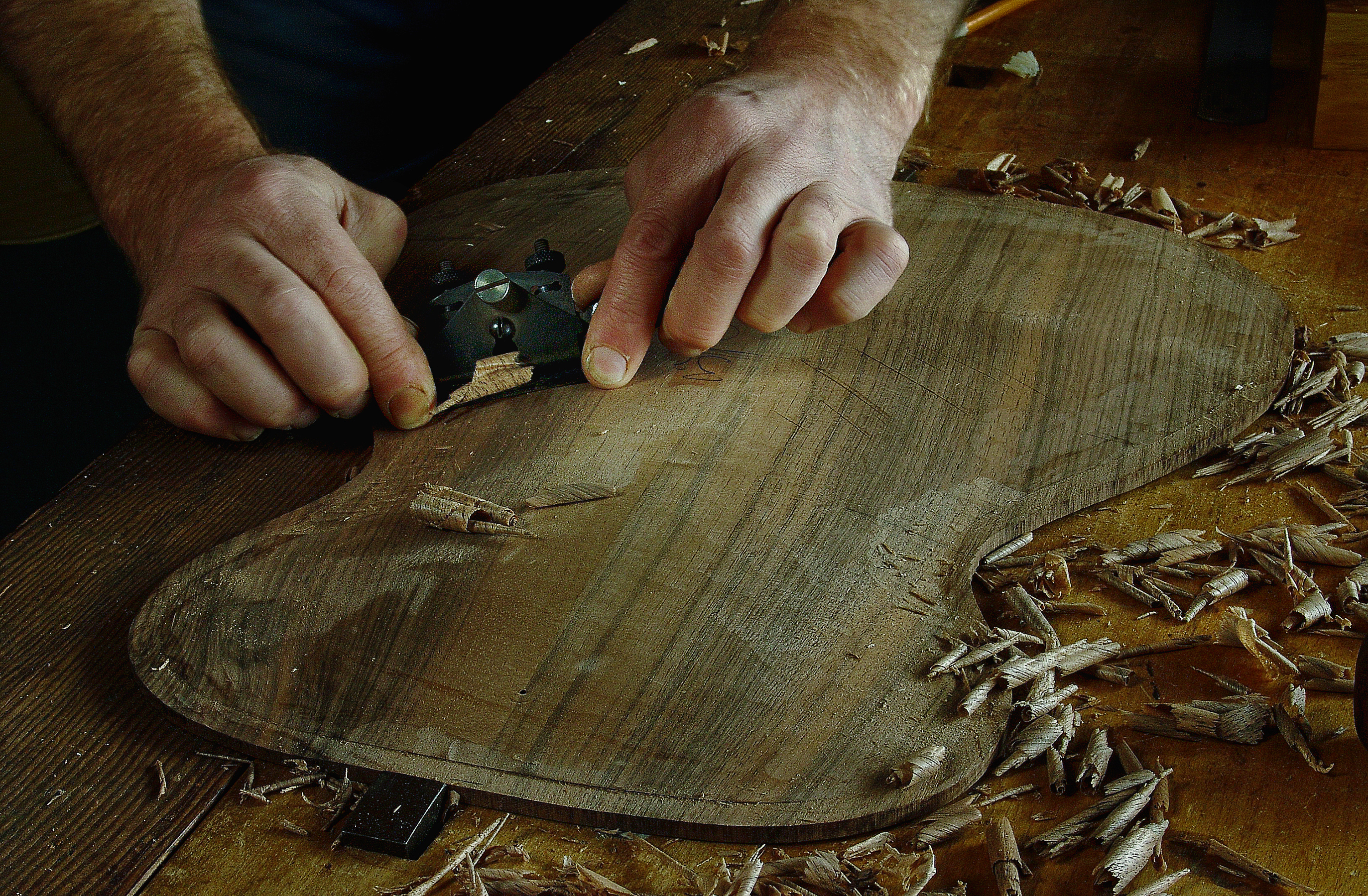 Peter Stephen works the plane over an archtop soundboard