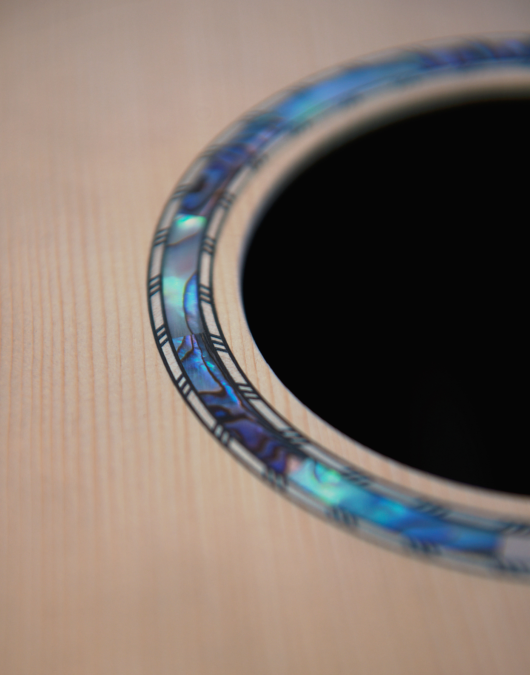 Guitar Maker Peter Stephen paua inlay around the sound hole of an acoustic guitar