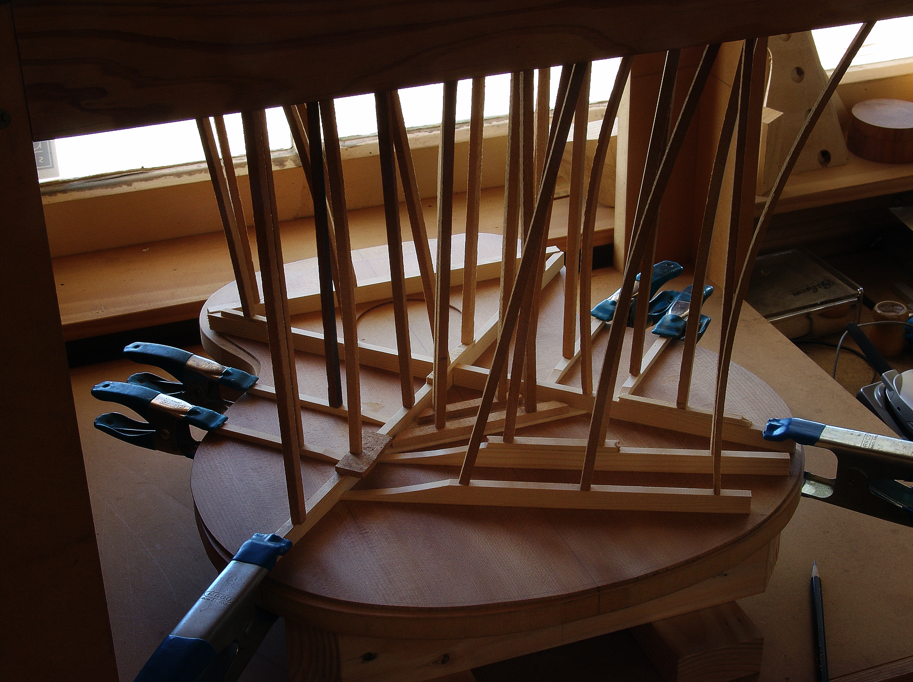 Luthier Peter Stephen glueing the bracings to a soundboard